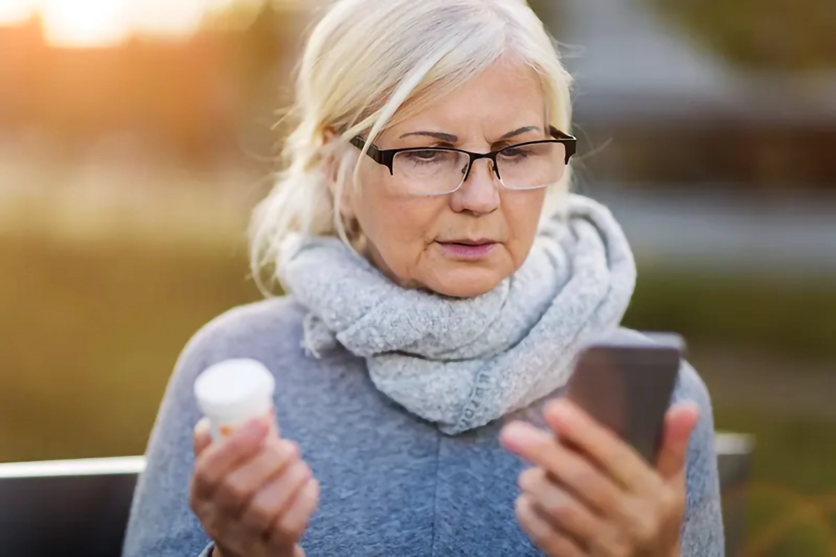 Image of a woman using a mobile to call the surgery