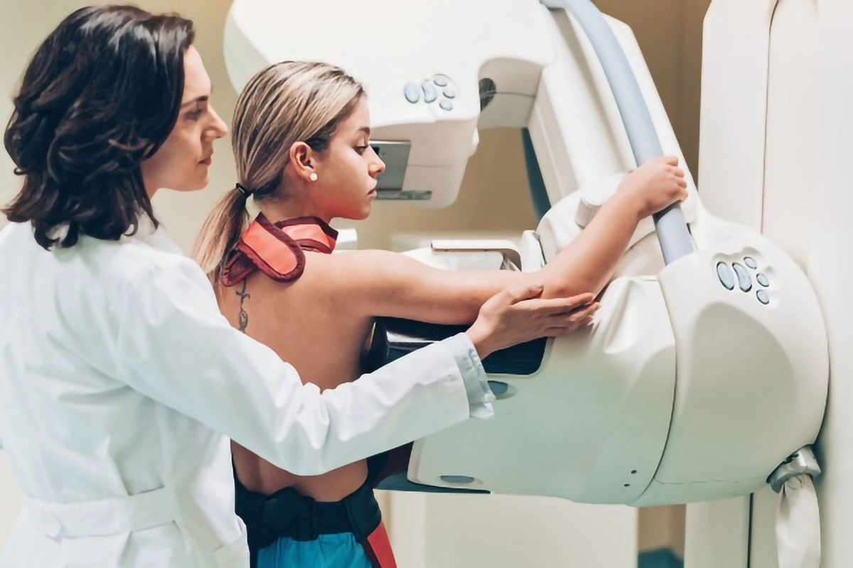 Image shows a female patient undergoing a mammogram