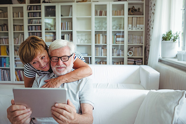 A couple looking at a tablet device